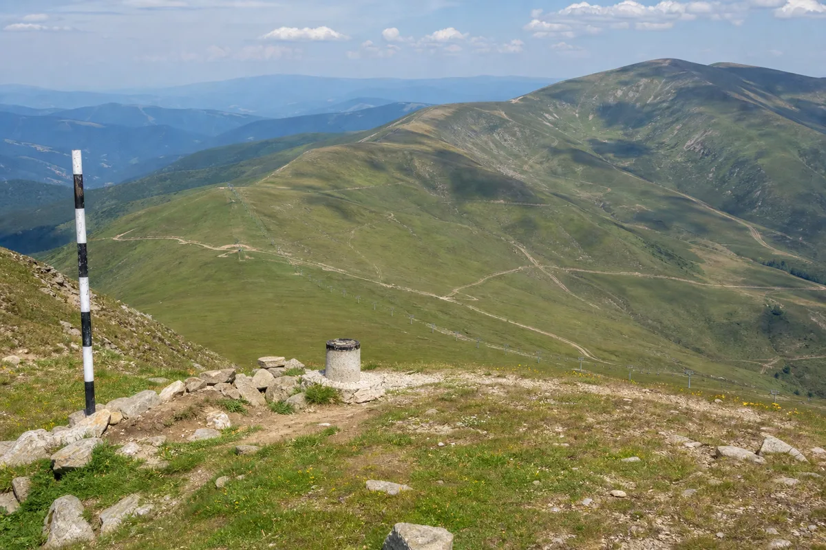 Panoramă de pe Vârful Bora peste culmile din jurul Obârșiei Lotrului, vara