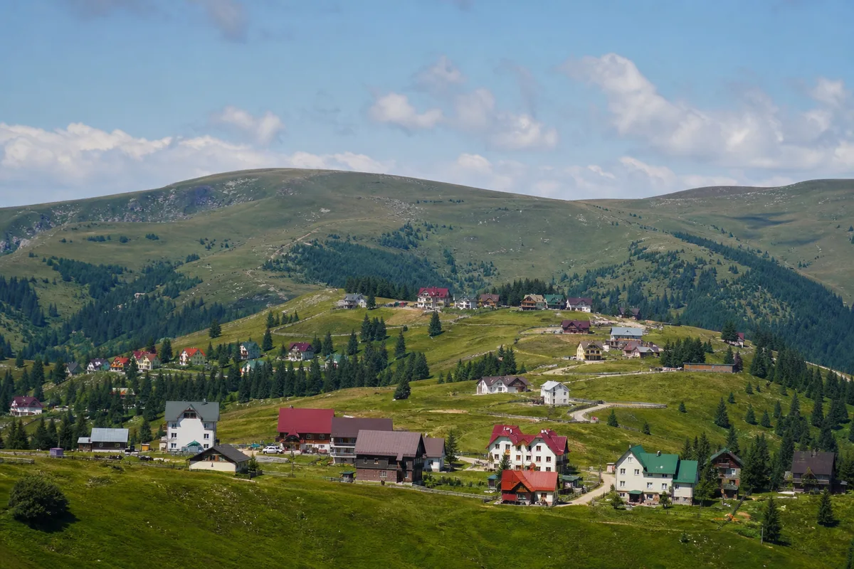 Stațiunea Rânca pe versantul sudic al Transalpinei, case montane și pajiști, vara